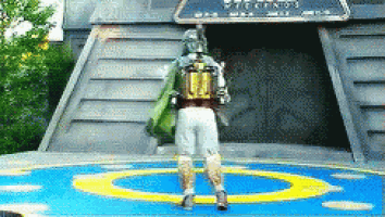 boba fett is standing in front of a building with a sign that says ' star wars ' on it