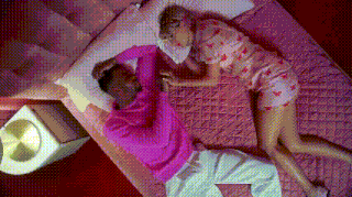 a man and a woman are laying on a bed together .