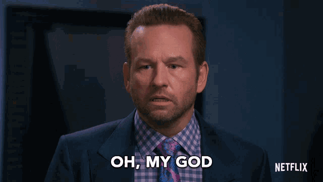 a man in a suit says oh my god