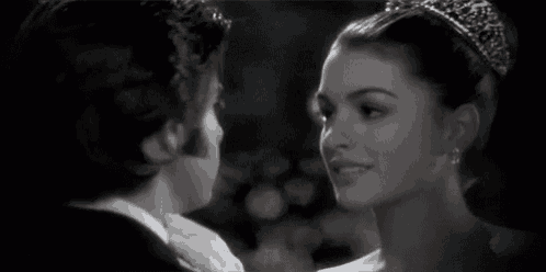 a man and a woman are looking at each other in a black and white photo