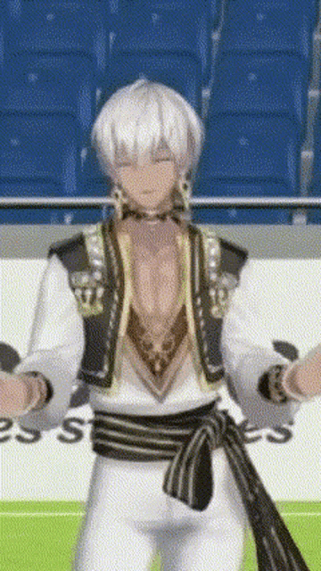 a man with white hair and a black belt is dancing in a stadium .