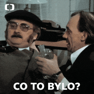 a man in a beret holds a glass while another man says co to bylo