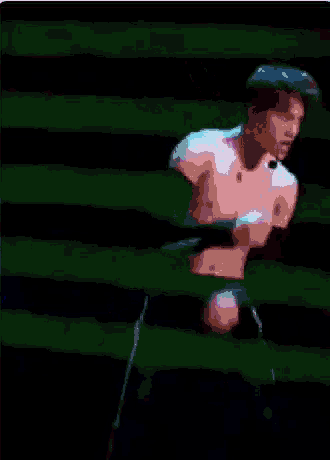 a pixelated image of a shirtless man dancing in a dark room