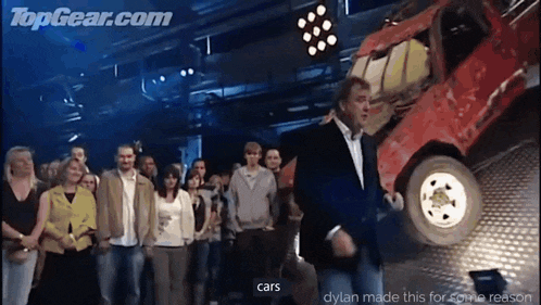 a group of people are standing in front of a red car that says cars on the bottom