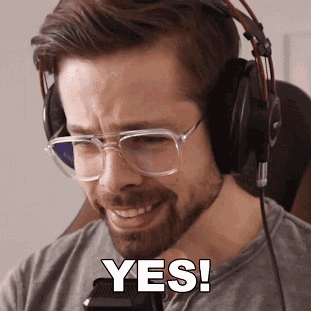 a man wearing glasses and headphones says " yes "