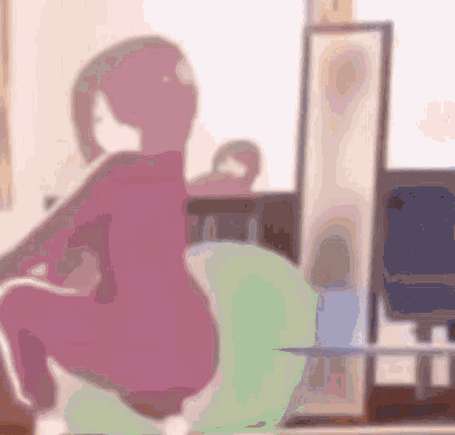 a blurry picture of a person squatting on a green ball