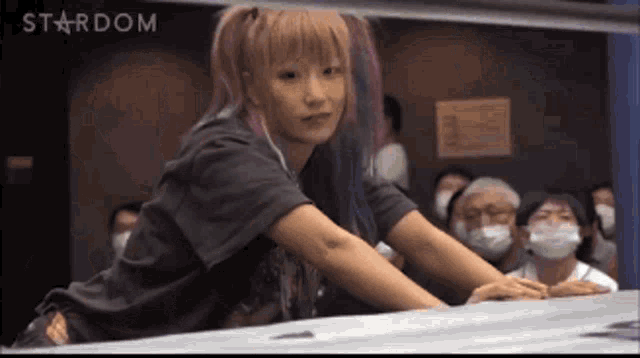 a woman in a wrestling ring with the word stardom on the bottom right corner