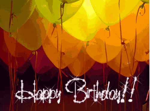 a bunch of yellow and orange balloons with the words happy birthday written in white