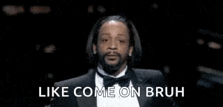 snoop dogg is wearing a tuxedo and smoking a cigarette .