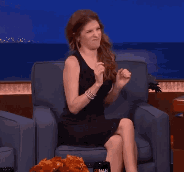 a woman in a black dress is sitting in a chair and the word gross is on the bottom