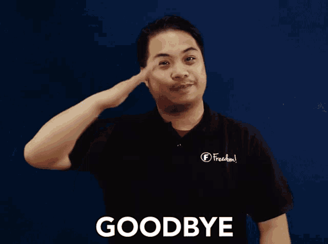 a man wearing a black shirt that says freedom says goodbye