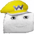 a white marshmallow wearing a yellow hat with a purple w on it .