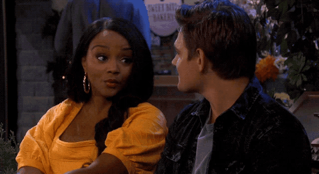a man and a woman are looking at each other in front of a sign that says sweet rice bakery