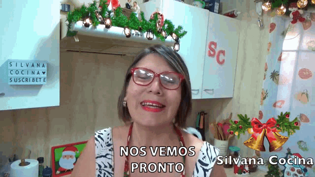 a woman in a kitchen with a sign that says sc on it