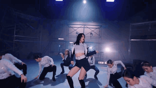 a group of dancers are dancing in front of a sign that says crew no