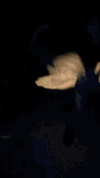 a blurry picture of a man 's fist in a suit and tie