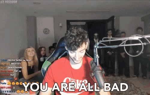 a man in a red coca cola shirt is standing in front of a microphone