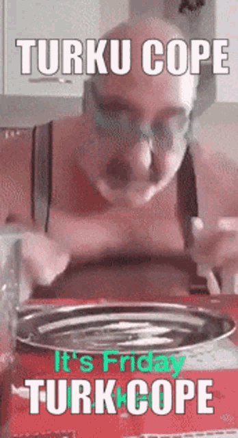 a man is sitting at a table with a plate in front of him that says turku cope on it