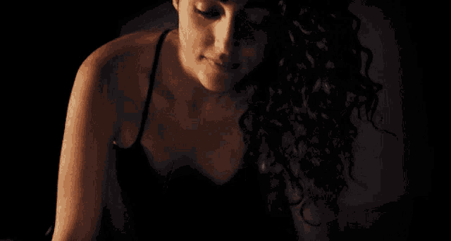 a close up of a woman 's face with curly hair