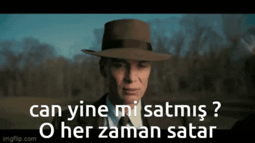 a man wearing a hat and a suit says can yine mi satmis o her zaman satar