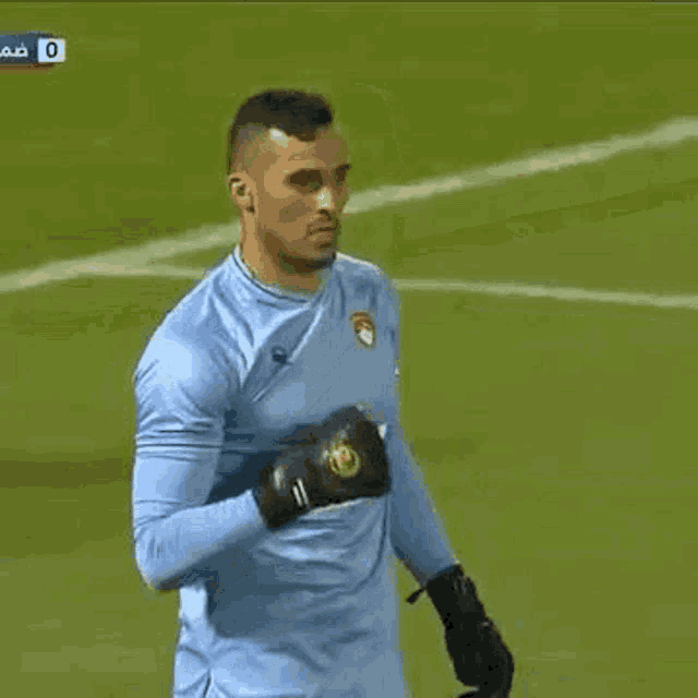 a soccer player wearing a blue jersey with the word arroi on the front