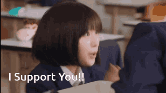 a girl in a classroom with the words i support you behind her