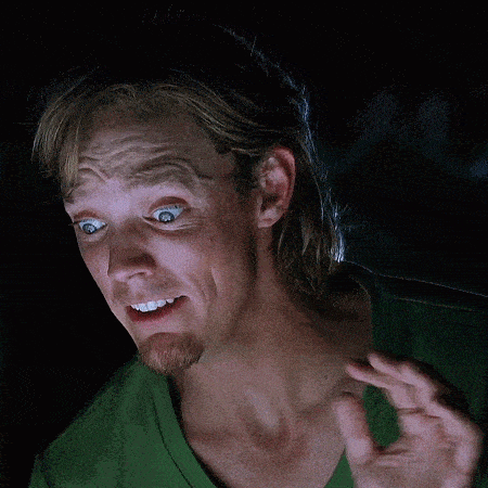a man in a green shirt making a funny face