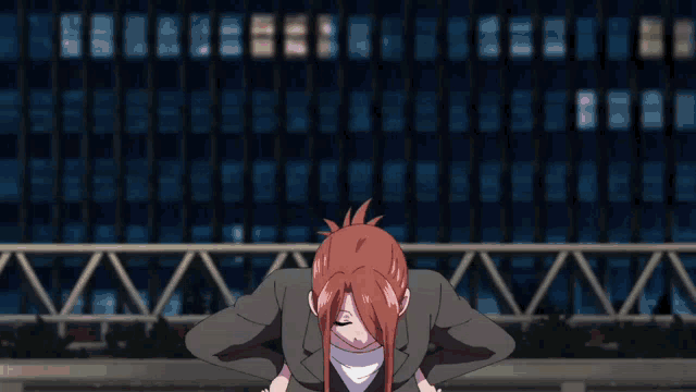 a woman with red hair stands with her hands on her hips in front of a building