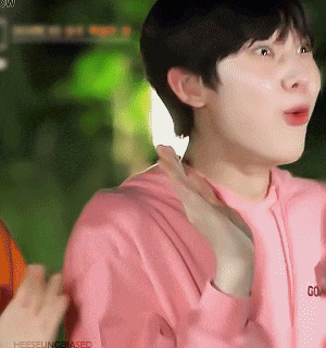 a close up of a person wearing a pink shirt that says go
