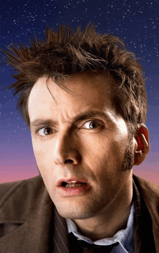 a man with a surprised look on his face is wearing a suit and tie