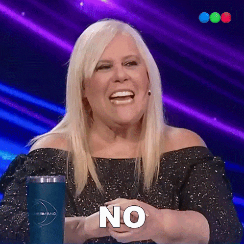 a woman with blonde hair is smiling and holding her hands together with the word no on her face