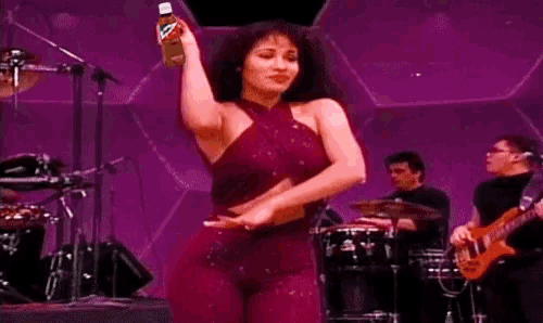 a woman in a purple outfit is holding a bottle of pepsi