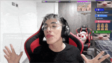 a man wearing headphones and glasses is sitting in a red chair