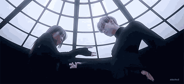 a man and a woman are standing in a room with a dome roof