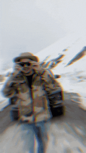 a blurry picture of a person in a hat and sunglasses