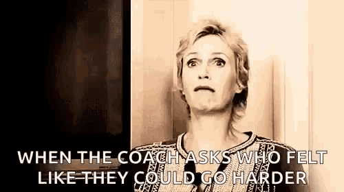 a woman is standing in front of a door and talking to a coach who felt like they could go harder .