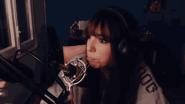 a woman wearing headphones and a shirt that says ' nvg ' on it