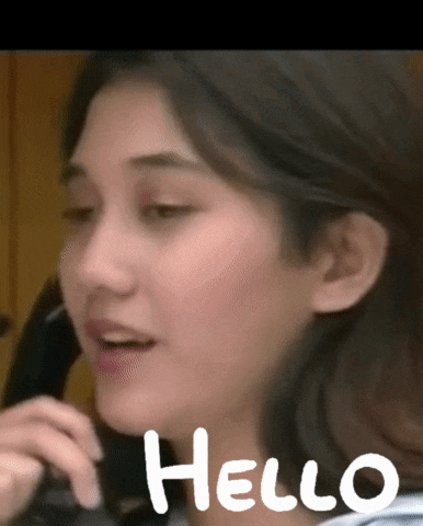 a close up of a woman talking on a phone with the word hello written below her