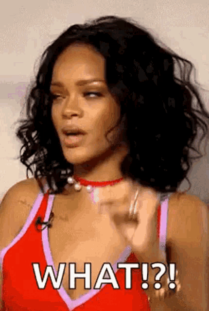 a woman in a red tank top is saying what ! ?