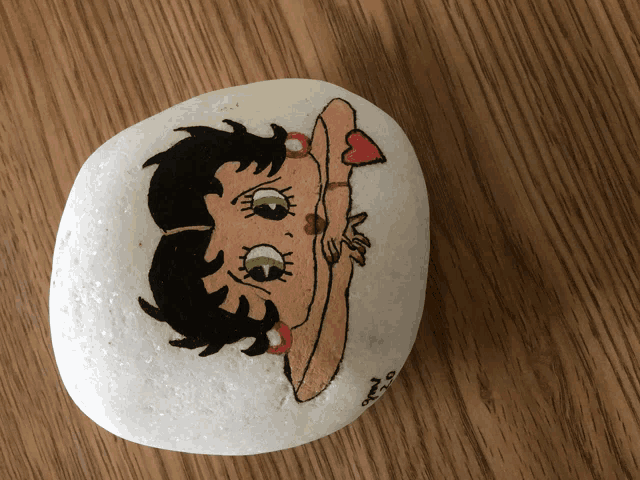 a white rock with a picture of betty boop on it