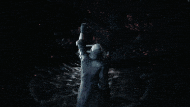 a blurred image of a person standing in the dark