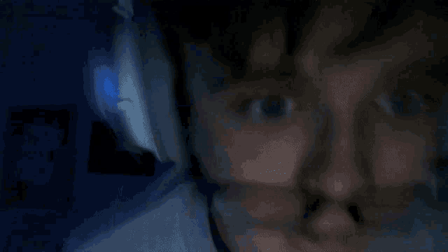 a blurry photo of a man 's face with headphones on