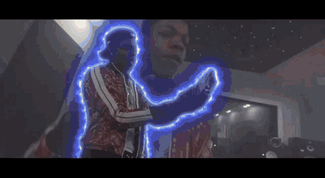 a man in a red jacket is surrounded by blue light