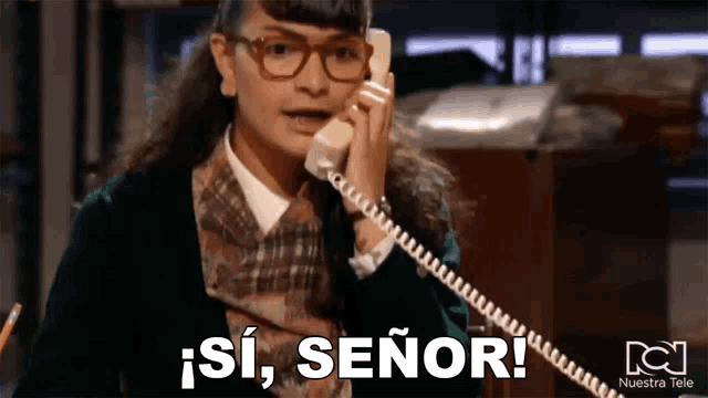 a woman wearing glasses is talking on a telephone and saying si , señor !
