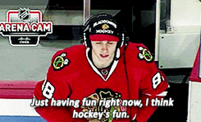 a hockey player wearing a red jersey with the number 8