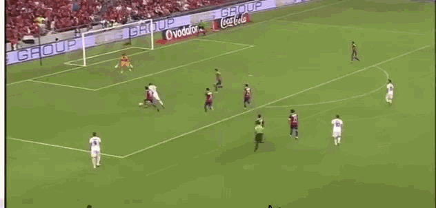 a soccer game is being played on a field with ads for coca cola and ceramica on the sidelines