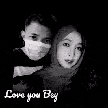 a man wearing a mask and a woman wearing a hijab hugging with the words love you bey written below them
