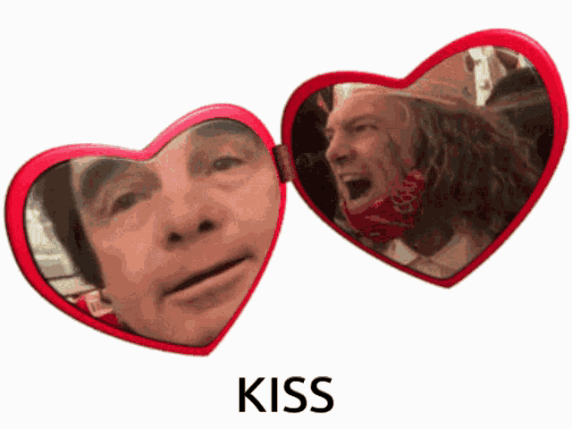 a red heart shaped mirror with a man 's face on it and the word kiss below it