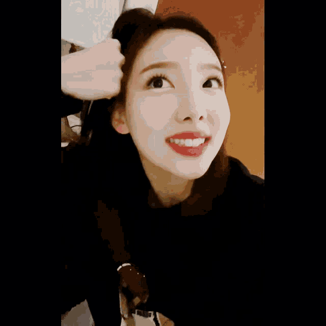 a close up of a woman 's face with a red lip