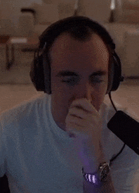a man wearing headphones and a watch is looking at something